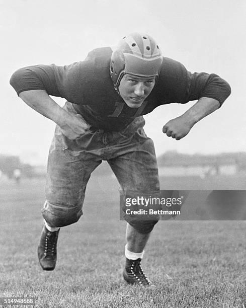 Full length, action posed, photograph of Al Wistert, football player for the University of Michigan Wolverines.