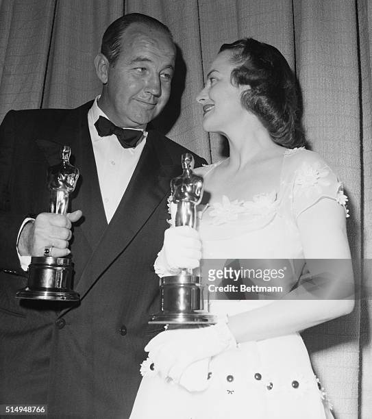 Broderick Crawford, star of the film All The Kings Men, and Olivia de Havilland, star of The Heiress, talk together after receiving Best Actor and...