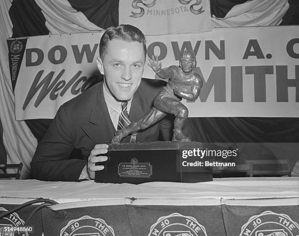 Bruce Smith, , the all America Captain of the University of Minnesota football team, receives the Heisman memorial trophy as an outstanding College...