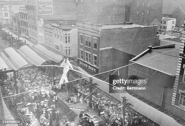 Philippe Petit performing at his first aerial show since his stunt crossing between the towers of the World Trade Center, walked blindfolded across a...