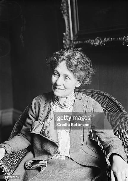 Mrs. Emmeline Pankhurst, the suffragette, seen here seated and smiling in a wicker chair. Undated photograph, circa 1915.