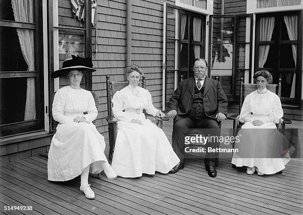 United States President William Howard Taft sits with his wife, Helen, and other members of his family on a porch. Undated photograph circa 1910.