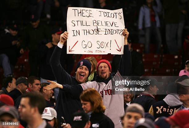 Two Boston Red Sox fans hold up a sign in celebration after the Red Sox defeated the New York Yankees 5-4 to win game five of the American League...