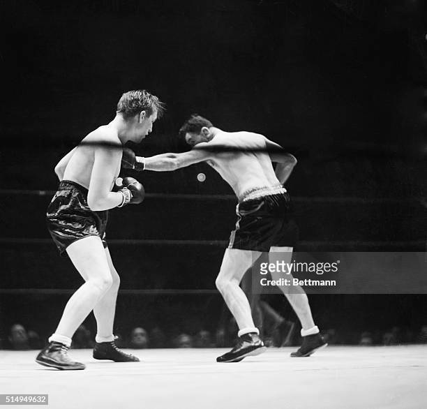 Jim Braddock lands a long left to Tommy Farr's chest in their ten-round bout at Madison Square Garden, New York City, January 21, 1938. With a last...