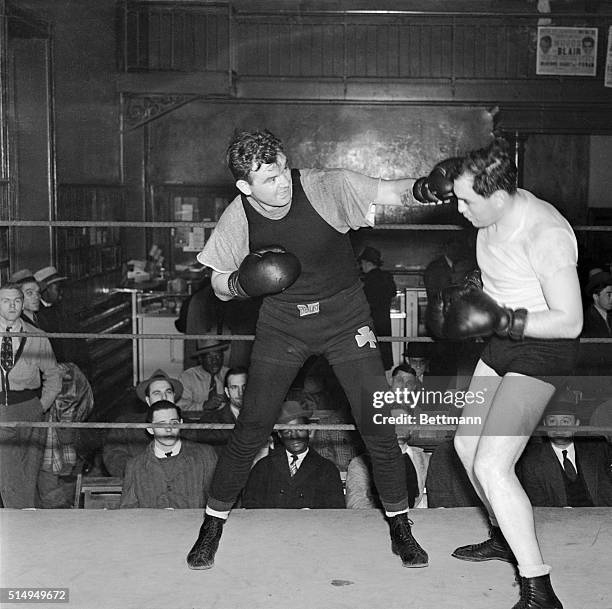 James J. Braddock, former heavyweight champion, shown left, lands a left jab to the head of a sparring partner at Stillman's Gymnasium, May 3, as he...