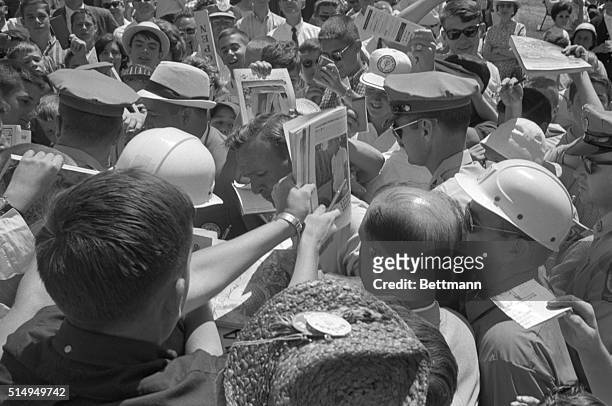 Arnold Palmer is surrounded by the troops of 'Arnies's Army' after he finishes a practice round at the Congressional Country Club, in preparation for...