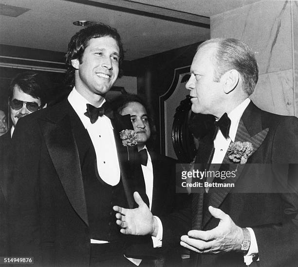 Chevy Chase of "NBC's Saturday Night" TV show with President Gerald Ford at a Washington Correspondent's dinner reception.