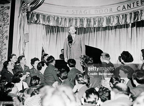 London, England: Secret Weapon...Der Bingle. Our own Bing Crosby holds the center of the stage as he croons one of his best numbers for the lads and...