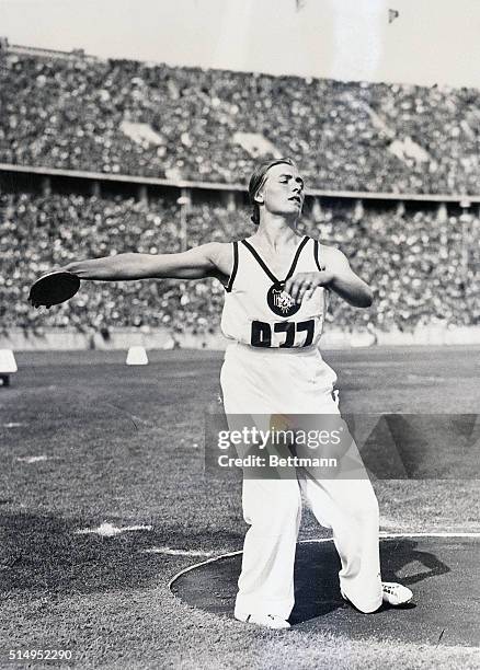 Berlin, Germany- Gisela Mauermayer of Germany, is shown as she was about to toss the discus for a distance of 156 feet,3 1/2 inches, for a new...