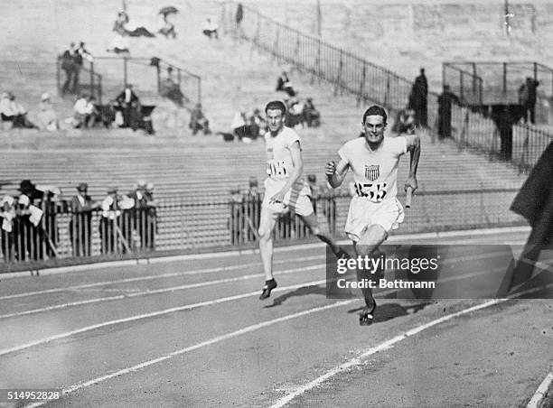 Paris, France- Picture shows relay team member, Stephenson, US, taking the baton from Cochran in the semi-final 1600-meter relay.