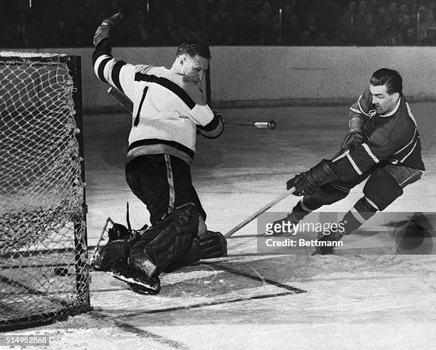 Montreal Canadien Maurice Richard scores on the Boston Bruin goalie Red Henry during the first period of the Montreal Canadiens-Boston Bruins game....