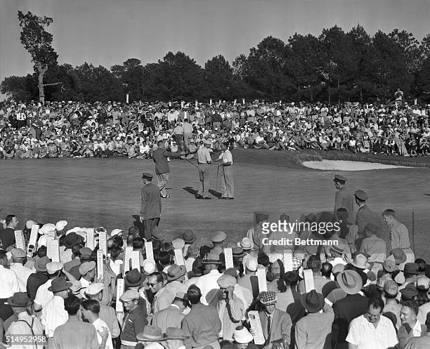Byron Nelson shakes hands with Ben Hogan after the hatless Texan sank a putt at the 18th hole to win the Masters Tournament, April 12. Hogan became...