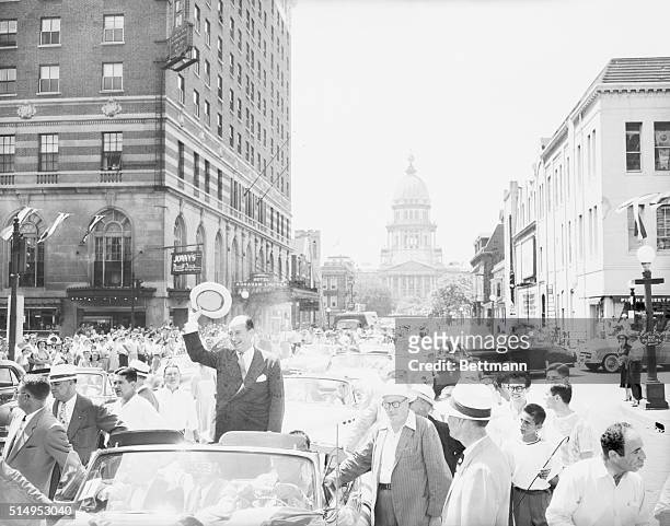 Democratic Presidential candidate Governor Adlai Stevenson , of Illinois, mops his brow in the sweltering heat that accompanies his welcome parade at...