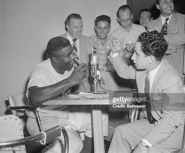 Dodger second baseman Jackie Robinson chats with Iraq's King Faisal in the press room at Ebbets Field following the game with the New York Giants...