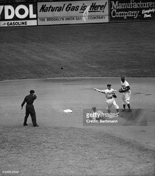 Speedy Richie Ashburn of the Philadelphia Phillies is "out by a mile" at second base on Johnny Wyrostek's grounder to Brooklyn Dodgers' second...