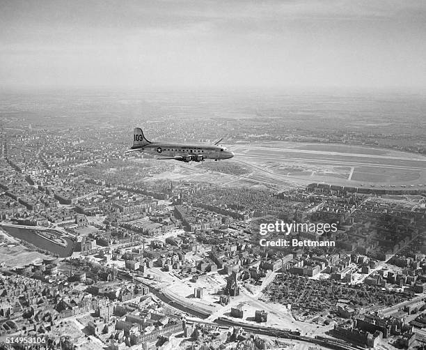 Air views show how Berlin looks to Vittles pilots as they approach Tempelhof airfield with their cargos of food and coal. Vittles plane circles...