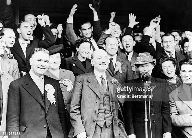 London, England- Major Clement Attlee, Britain's new Prime Minister, is shown with his wife as they were acclaimed by supporters after the great...