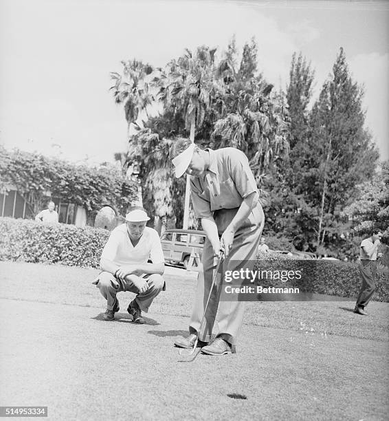 Jug McSpaden and teammate Byron Nelson set their sights for the first money in $7,500 International four ball invitation golf tourney at Miami...