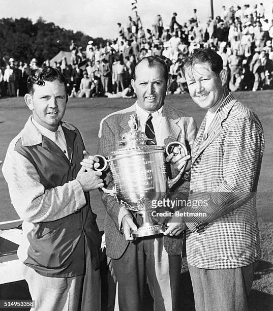 You wouldn't know by looking at their faces who is the winner and who the loser here. Byron Nelson , of Toledo, Ohio, is being presented with the cup...