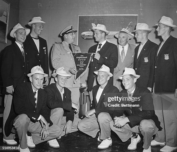 Arriving in New York's International Airport from Helsinki, Robert M. Detweiler number five man of the Navy's eight-oar-with coxswain crew, presents...