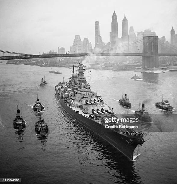 The mighty surrender warship, USS Missouri shown sliding under the Brooklyn Bridge today, Nov 19th, en route to the Brooklyn Navy Yard where she will...