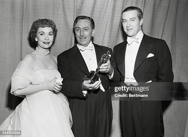 Feature-length cartoon producer Walt Disney holds the Oscar presented to him at the 25th Annual Academy Awards presentations. Disney's Water Birds...