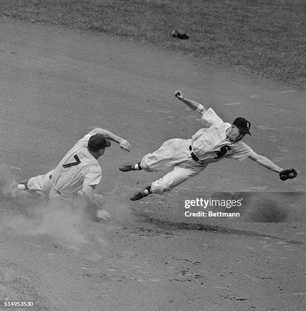 Nellie Fox, white Sox second basemen, is pulled off the bag, as Mickey Mantle of the Yankees pulls off a steal during the first inning of their game...