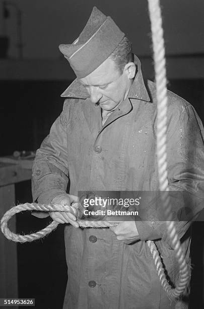 Nuremberg, Germany: Nazi necklace being prepared by M/Sgt. John C. Woods, official Hangman for the European Theater of Operations with 92 hangings to...