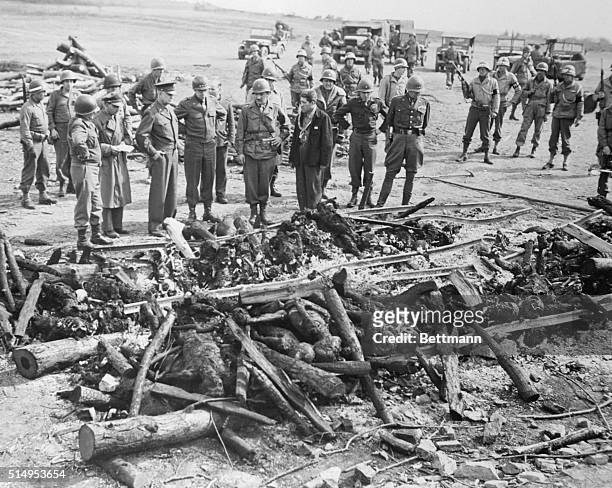 Eisenhower, Patton and Bradley - America's three top Generals in Europe - inspect the charred remains of prisoners in Gotha Concentration Camp who...