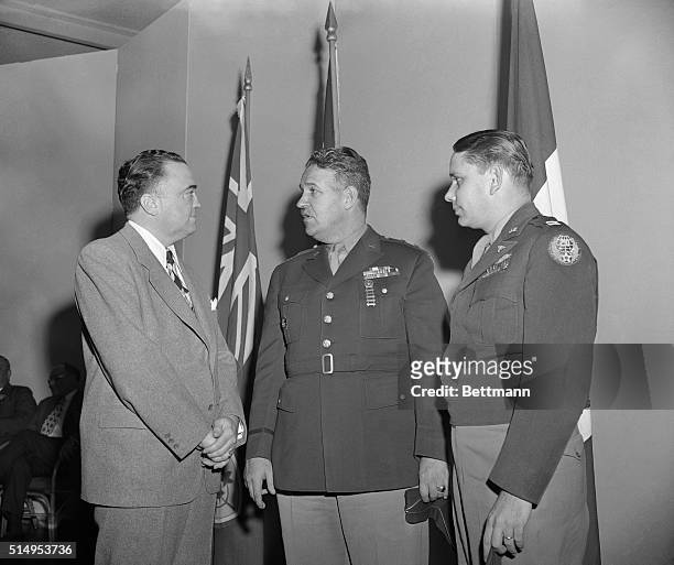 Edgar Hoover, , Chief of the FBI, talks with Maj. Gen. Leslie R. Groves , head of the Atomic Bomb Project, and Captain Donald Albury , co-pilot of...