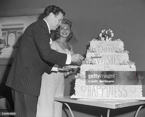 Giant Cake for Dick and Rita. Las Vegas, Nevada: Actress Rita Hayworth and her new husband, Dick Haymes, cut their giant wedding cake shortly after...