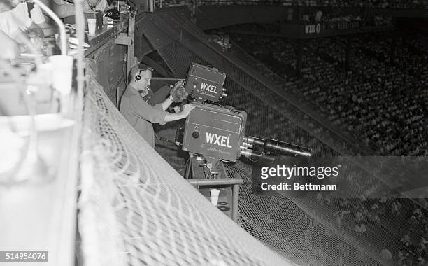 Cameramen get into the act--in self defense--whenever a "hot" foul landed in their stand behind home plate at Cleveland Stadium. Technicians took to...