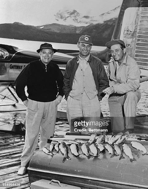 Ben Hogan , internationally-famous golfer, is pretty good at trout fishing, too. He is shown with his fishing companions R.J. Caraway and Pollard...