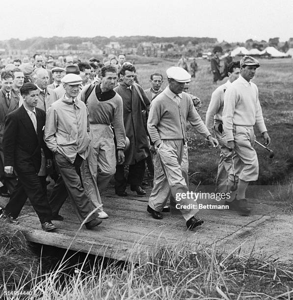 With spectators bringing up the rear, Ben Hogan crosses a small bridge on his way to the first green of the Burnside Course for his last practice...