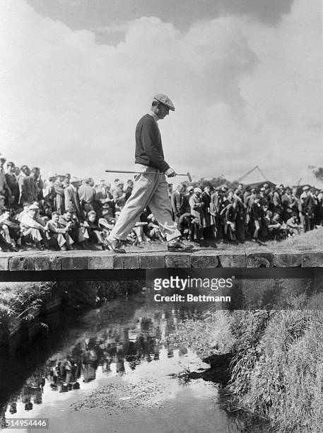 Ben Hogan crosses a stream on the Carnoustie Golf Course while a huge crowd awaits his next shot in the British Open Championship. The American...