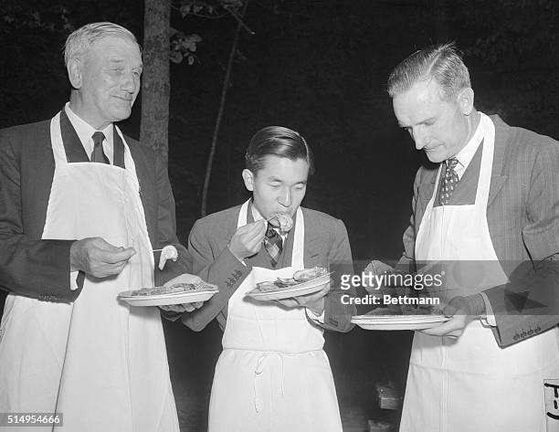 Prince Enjoys US Oysters. Williamsburg, Virginia: Crown Prince Akihito of Japan enjoys a dish of oysters at an oyster roast held during his visit to...