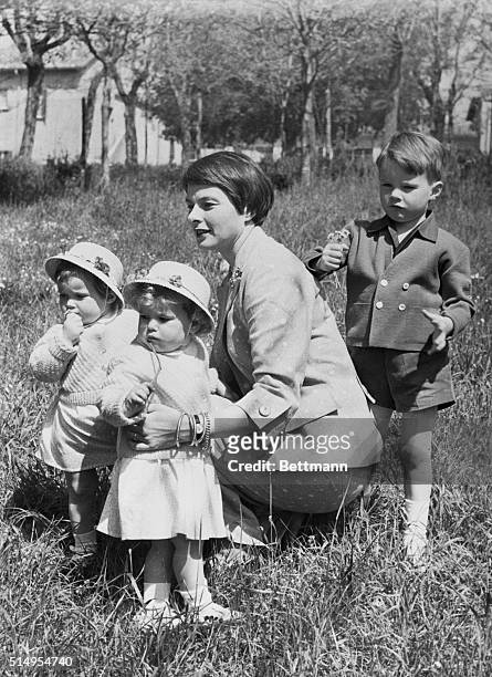 Takes Time Out from "Burning" Rome: Still wearing her Joan of Arc hairdo, Swedish-born actress Ingrid Bergman takes her children into the warm...