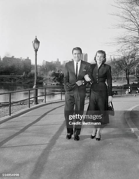 Newly-bethrothed Patricia Kennedy and Peter Lawford, British-born actor, are caught by the camera while enjoying a brisk walk around Central Park in...