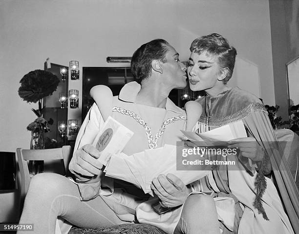 Audrey Hepburn and Mel Ferrer, co starring in the romance Ondine by Jean Giraudoux, give each other an opening night kiss, February 18th, at the 46th...