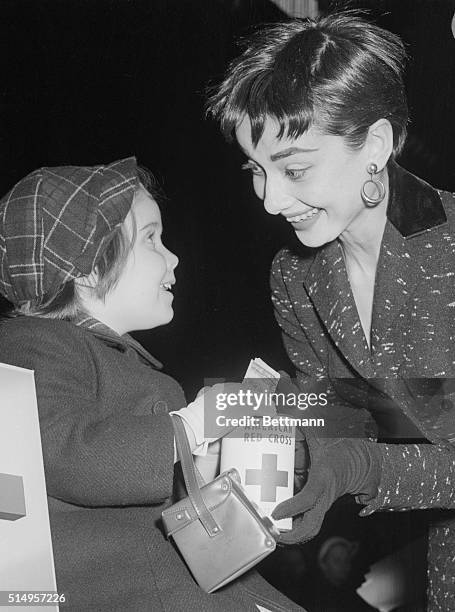 Miss Audrey Hepburn, star of the current Broadway play, Ondine, holds a quick conference with Peggy Ann Malone, the three year old daughter of Mr....