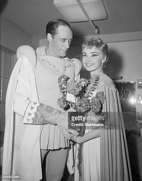 Costars Audrey Hepburn and Mel Ferrer hold flowers backstage at the opening of the play Ondine, February 18th, at the 46th Street Theater. Presented...