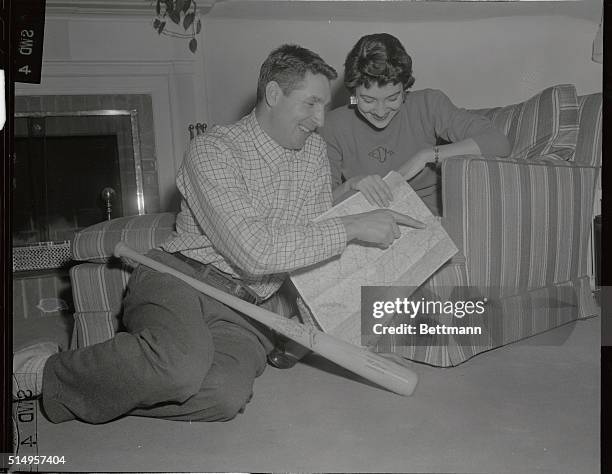 Bobby Thomson shows his wife Elaine the route to Milwaukee on a road map after they received the news that the New York Giants had traded him to the...