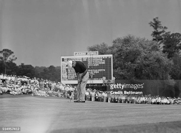 Ben Hogan putts out on the 18th hole of the first round of the Masters Golf Tournament. Later, Hogan and Sam Snead tied for first place and had to go...
