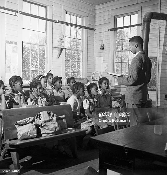 Uno,Virginia- Teacher Jackson is reading to his pupils here. All of them were born in Uno and come from ten families that make up the entire...