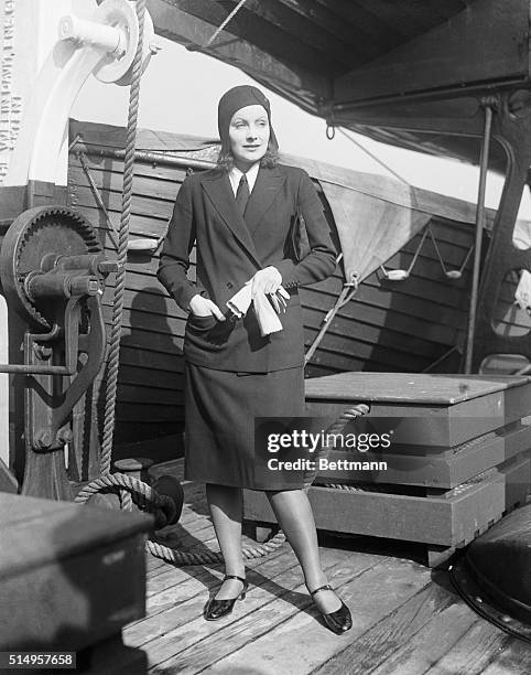 Screen star returns from vacation abroad. Greta Garbo, noted screen star returning from vacationing in her native Sweden, pictured as she arrives in...