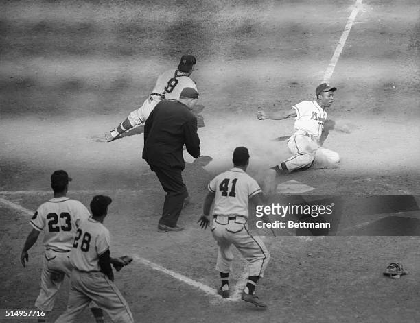 Milwaukee Braves left fielder Hank Aaron scores the winning run in the seventh inning of the July 25th game with the New York Giants on Andy Pafko's...