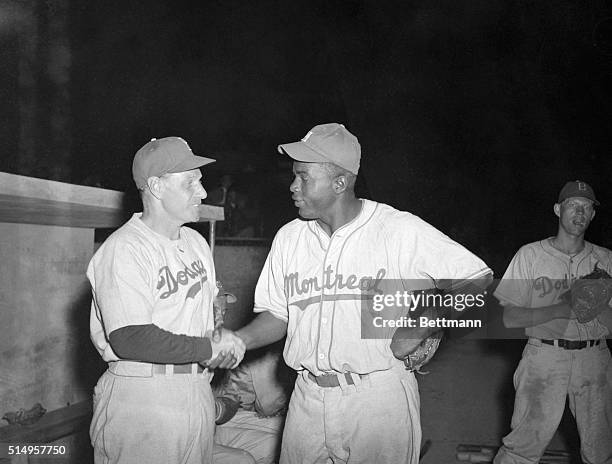 Jackie Robinson , Negro infielder with the Montreal Royals, farm team of the Brooklyn Dodgers, is greeted by Leo Durocher, the Dodger's manager, at...