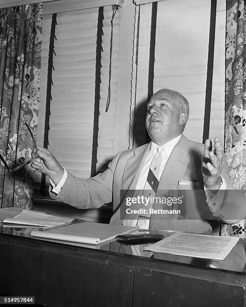 Warren Giles, President of the National League, gestures as he looks over reports of the riot that took place during the second game of the July 18th...