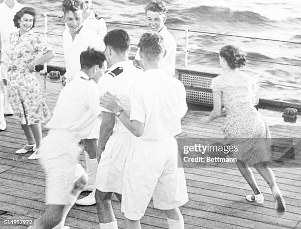 Princess Margaret Rose eludes a midshipman while playing a game of tag aboard the HMS Vanguard. The two princesses, Princess Elizabeth II pictured at...