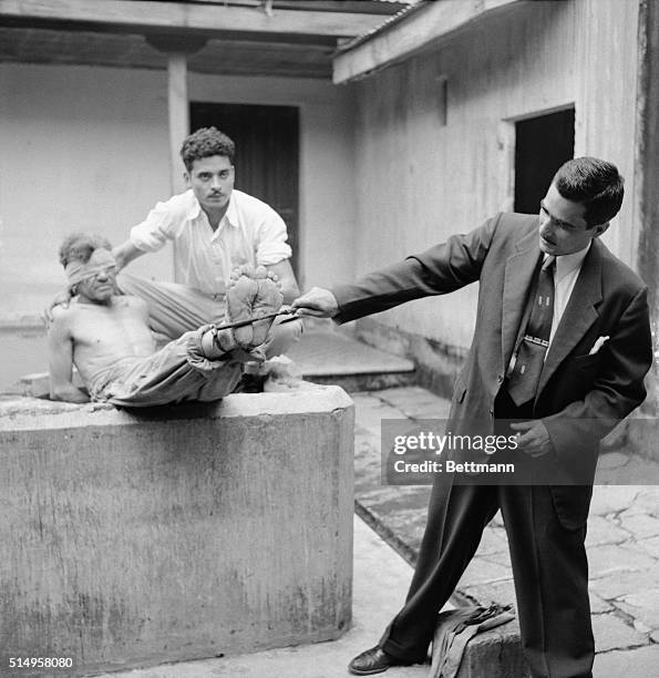 Mario Sandoval , a prisoner of the regime overthrown by the Liberation Army of Carlos Castillo Armas, demonstrates with two other former prisoners...